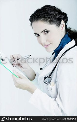 Female doctor writing on a clipboard