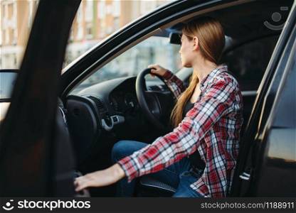 Female driver beginner sitting in a car. Woman in vehicle, driving automobile concept. Female driver beginner sitting in a car