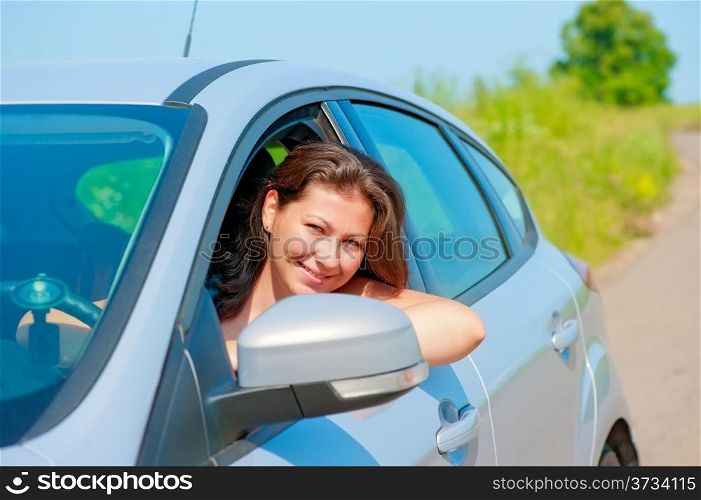 female driver looks out the car window