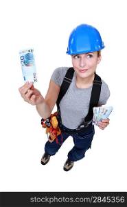 Female electrician counting money