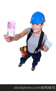 Female electrician holding money