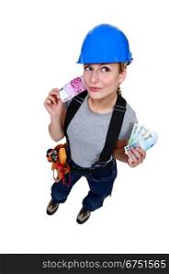 Female electrician with cash