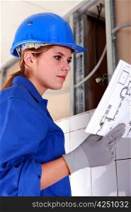 Female electrician with diagram