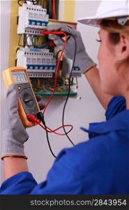 Female electrician with voltmeter