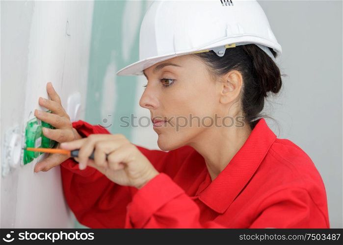 female electrician working on socket