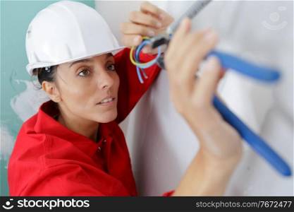 female electrician working on wiring