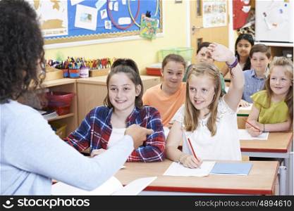 Female Elementary Pupil Answering Question In Class