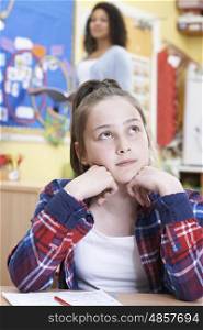 Female Elementary School Pupil Daydreaming In Class