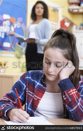 Female Elementary School Pupil Struggling In Class