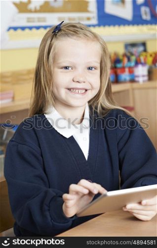 Female Elementary School Pupil Using Digital Tablet In Class