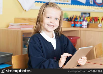 Female Elementary School Pupil Using Digital Tablet In Class