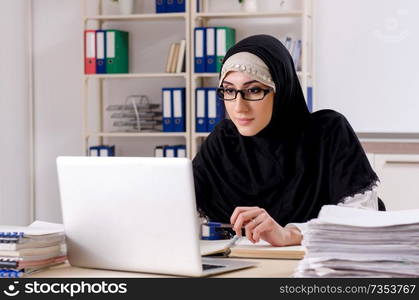 Female employee in hijab working in the office 