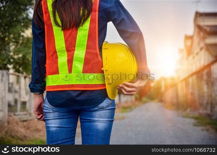 Female Engineer holding hardhat safety Standing outdoor work place