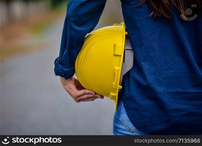Female Engineer holding hardhat safety Standing outdoor work place