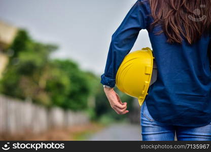 Female Engineer holding hardhat safety Standing outdoor work place