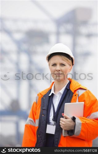 Female engineer holding tablet PC in shipping yard