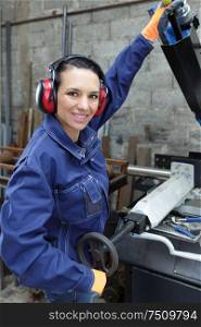 female engineer using machine in factory