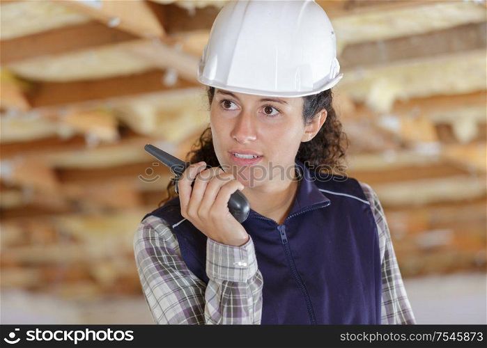 female engineer using walkie-talkie indoors
