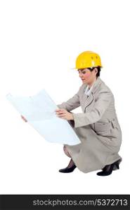 Female entrepreneur crouching on white background