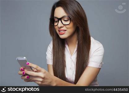 Female executive reading an sms on mobile phone