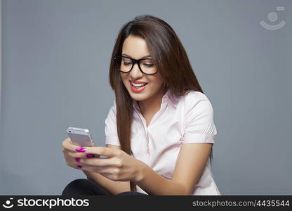 Female executive reading an sms on mobile phone