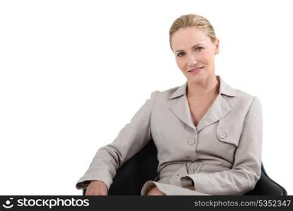 Female executive sitting in leather chair