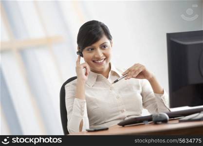 Female executive talking on a blue-tooth headset