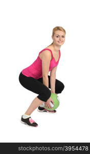 Female exercise with medicine ball. Phase 1 of 2, squatting before throw.
