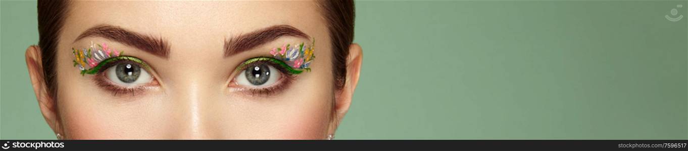 Female eye with flower makeup eyes. Spring makeup. Beauty fashion. Eyelashes. Cosmetic Eyeshadow. Make-up detail. Close up, Macro