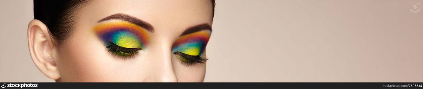 Female eye with rainbow make-up. Long eyelashes, vivid colorful eyeshadows. Beauty. Close up, Macro