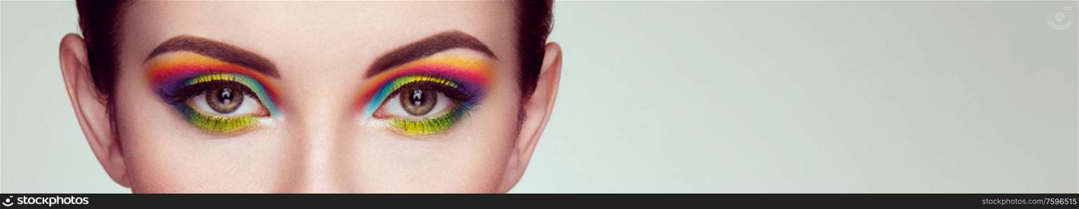 Female eye with rainbow make-up. Long eyelashes, vivid colorful eyeshadows. Beauty. Close up, Macro