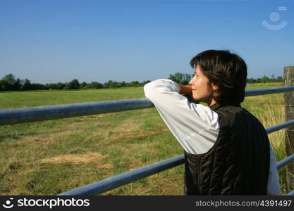Female farmer stood looking at her land