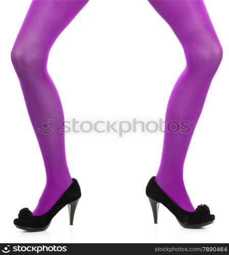 Female fashion. Woman with long legs violet color stockings and black high heels isolated on white background