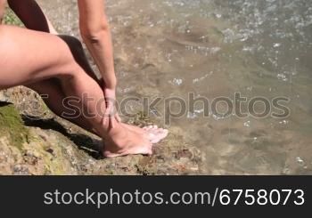 female feet by the waterfall