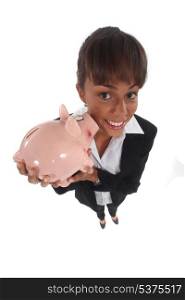 Female financial worker stood with piggy bank