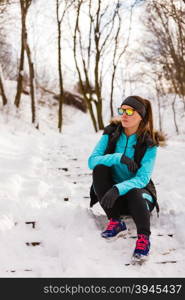 Female fitness sport model outdoor in cold winter weather . Sports and activities in winter time. Slim fit fitness woman outdoor. Athlete girl training wearing warm sporty clothes outside in cold snow weather.