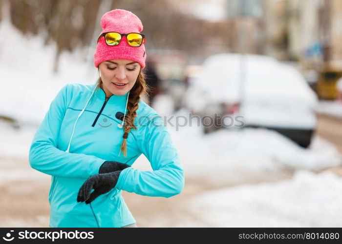 Female fitness sport model outdoor in cold winter weather . Sports and activities in winter time. Slim fit fitness woman outdoor. Athlete girl training wearing warm sporty clothes outside in cold snow weather.