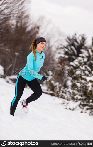 Female fitness sport model outdoor in cold winter weather . Sports and activities in winter time. Slim fit fitness woman outdoor. Athlete girl training wearing warm sporty clothes outside in cold snow weather.