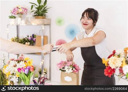 female florist accepting credit card from her customer