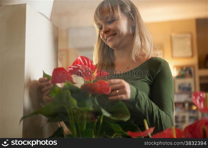 Female florist is taking care of her plants