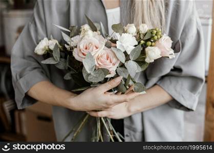 female florist making beautiful floral arrangement