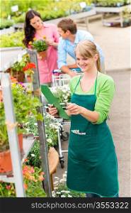 Female florist working at garden centre retail inventory