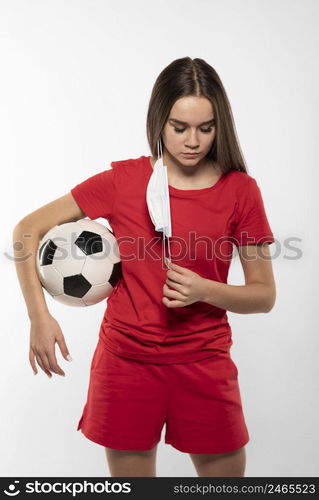 female football player with mask holding ball 4