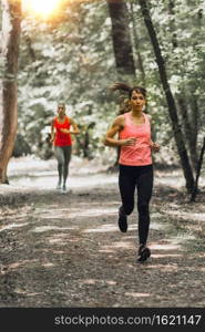 Female Friends Enjoy Running Outdoors