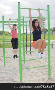 female friends exercising at outdoor gym