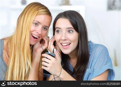 Female friends listening to music