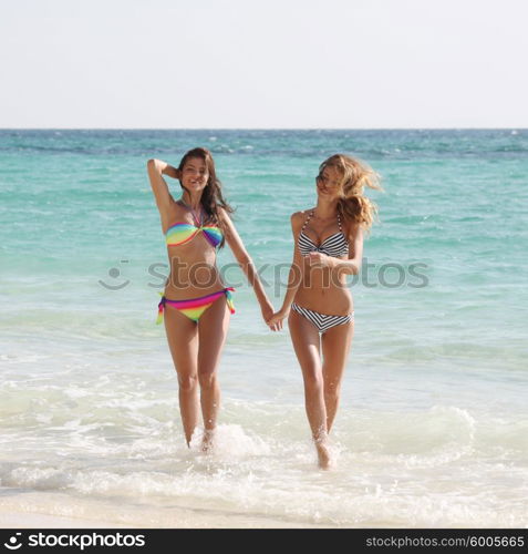 Female friends on vacation. Happy smiling female friends in bikini on vacation