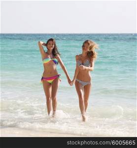 Female friends on vacation. Happy smiling female friends in bikini on vacation