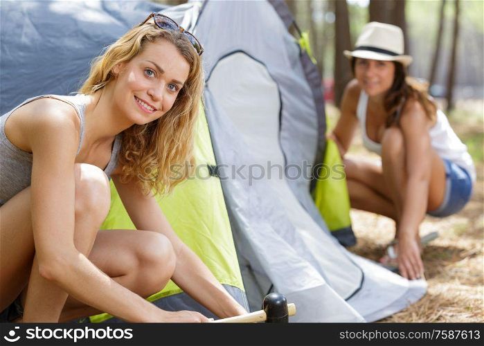 female friends pitching up their tent