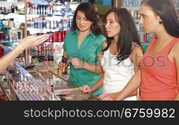 Female Friends Shopping for Cosmetics in Beauty Department